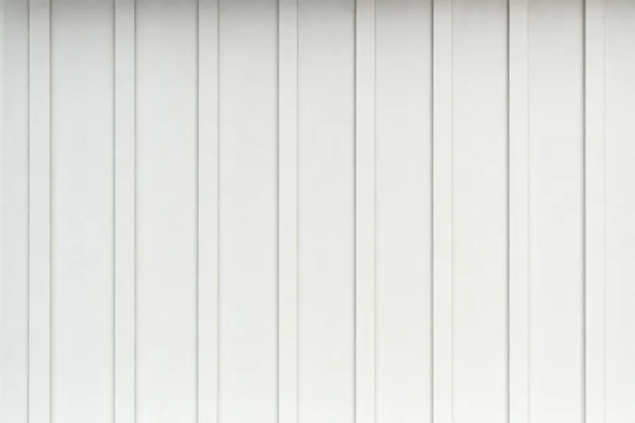 White board and batten siding: wide flat vertical boards with narrow battens covering every seam.